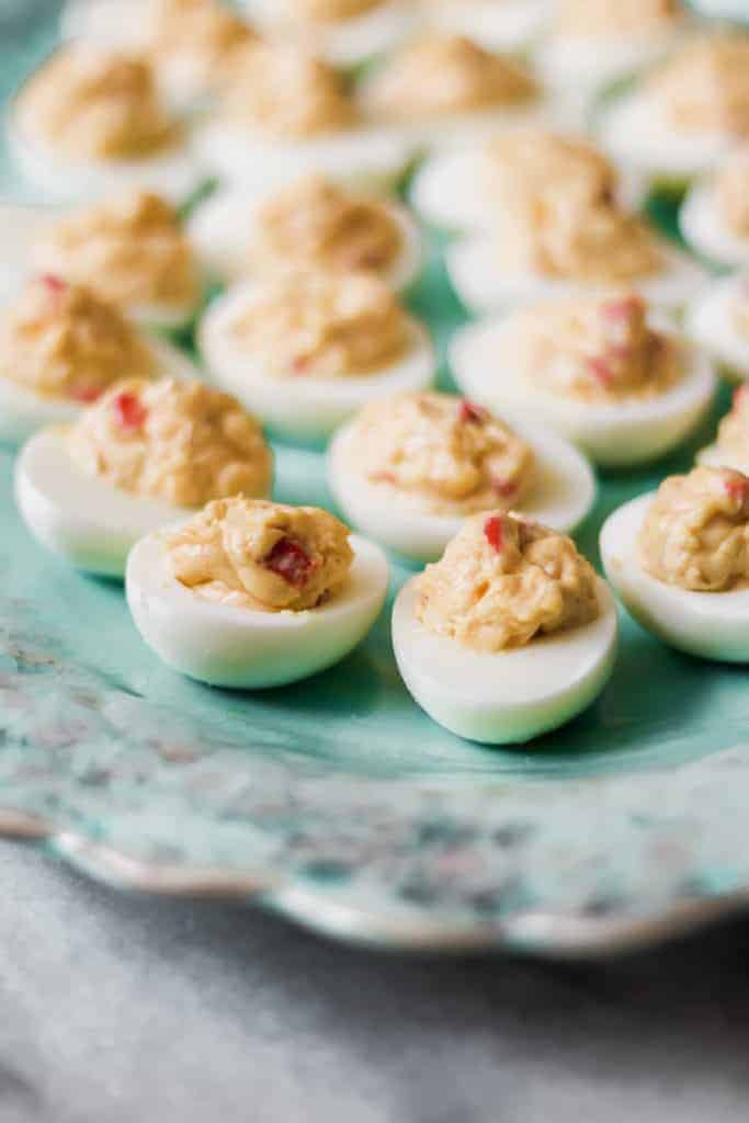 platter of pimento cheese deviled eggs on a marble board