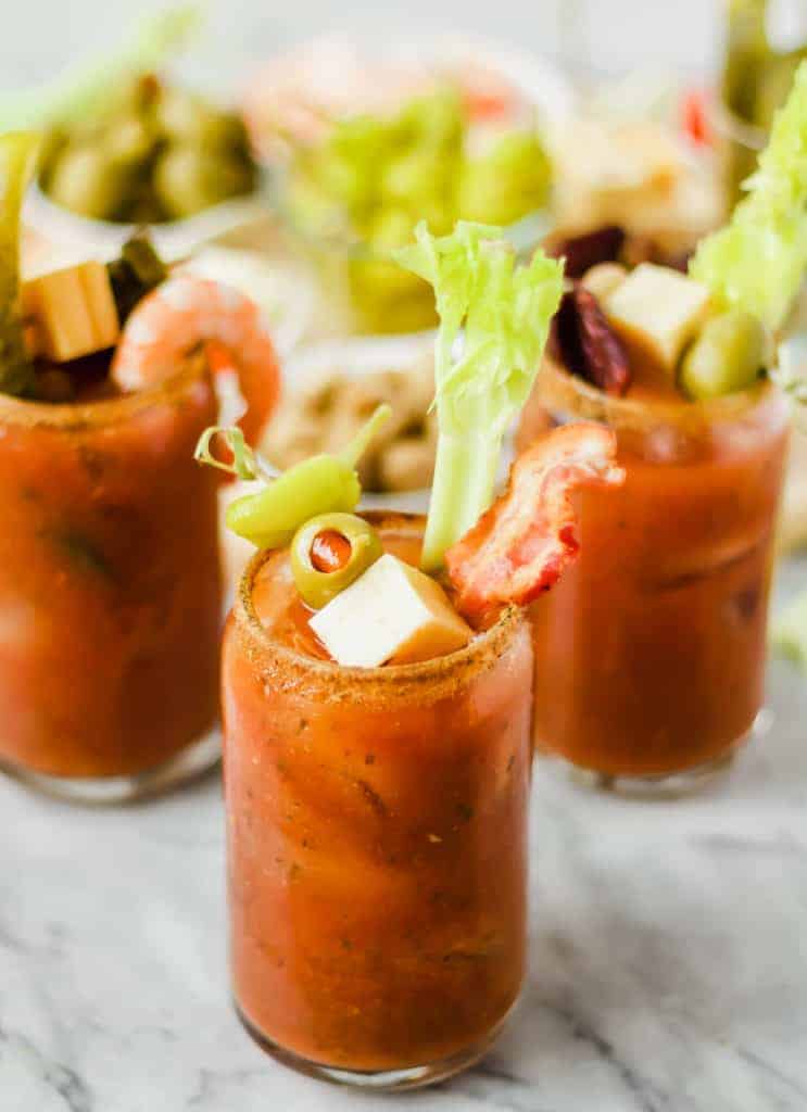 three bloody marys with toppings