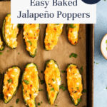 Easy baked jalapeño poppers filled with cheese on a parchment-lined baking sheet.