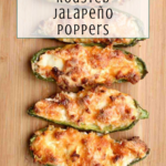 Five roasted jalapeno poppers stuffed with melted cheese are arranged in a vertical row on a wooden board. Text at the top reads Easy Recipe Roasted Jalapeño Poppers.