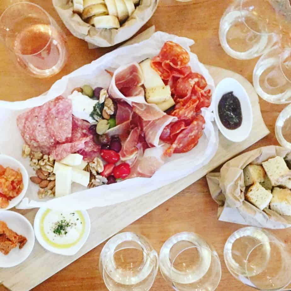 charcuterie board and wine flights on a wood table