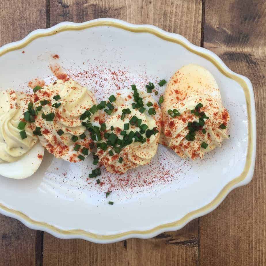 deviled eggs on a plate and wooden table at habderdish noda