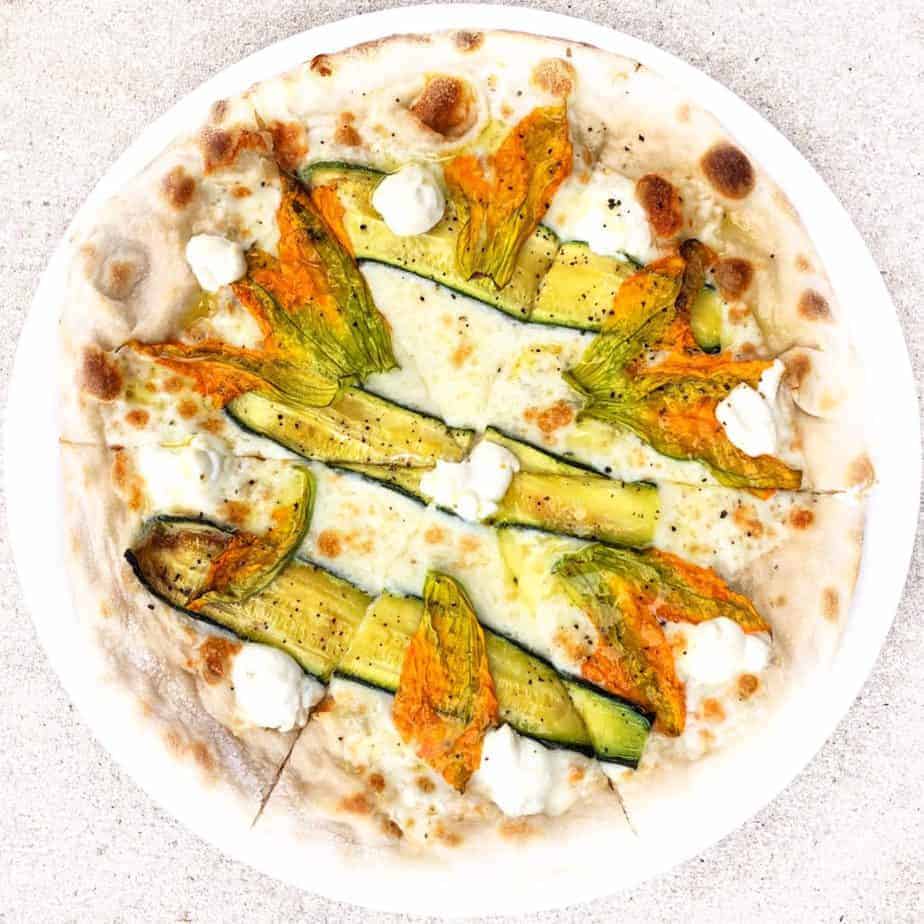 seasonal pizza with squash blossoms and zucchini at pizzeria omaggio in charlotte nc