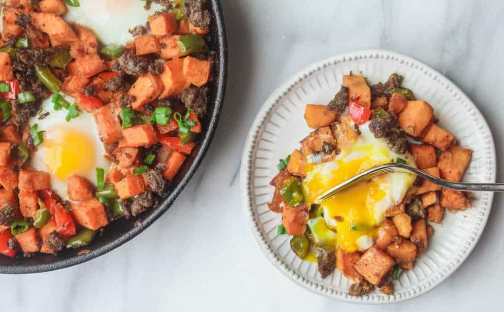 cast iron pan full of sweet potato hash is a great whole30 breakfast idea