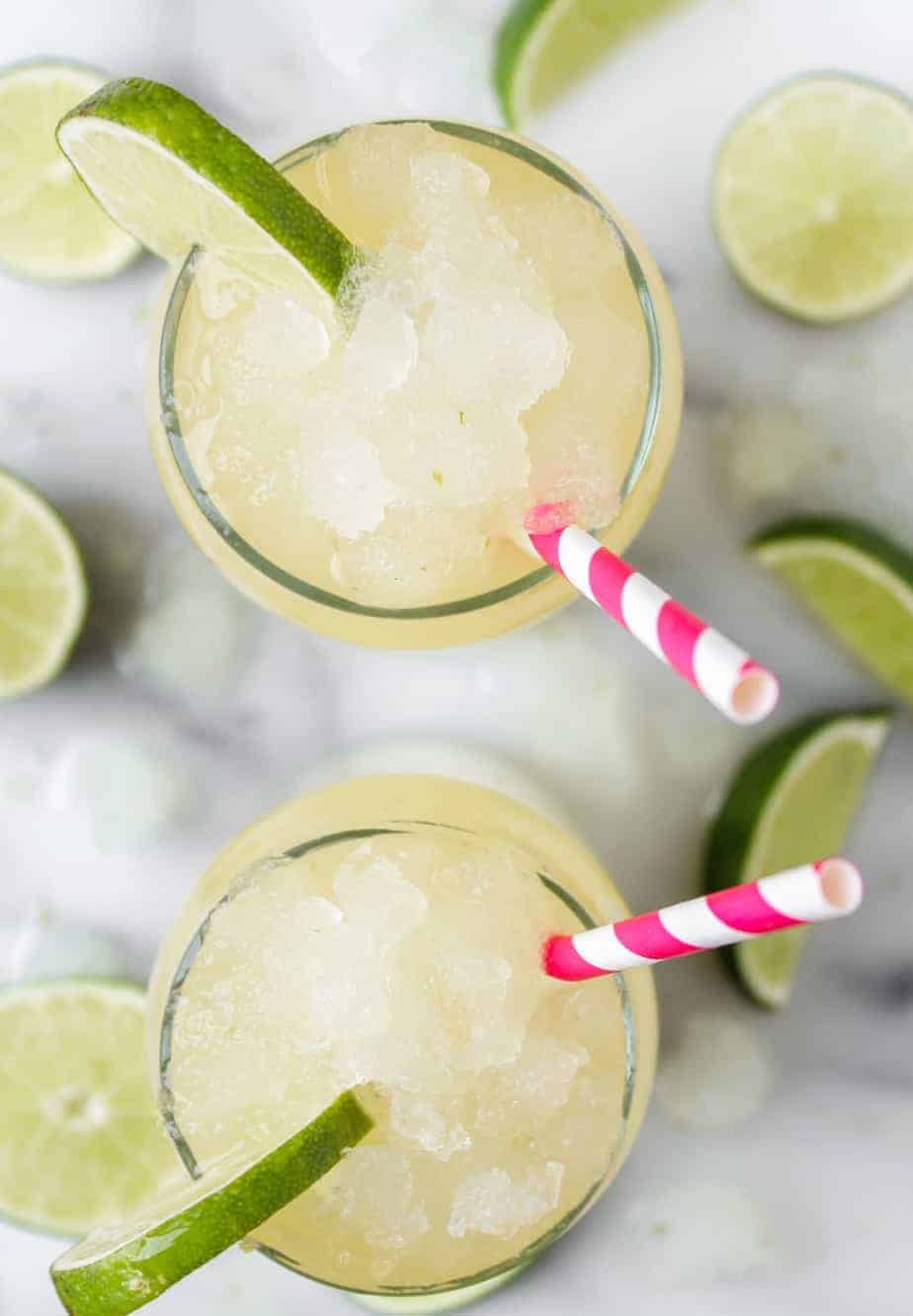 corona cocktail with limes and corona extra beer and pink striped straws