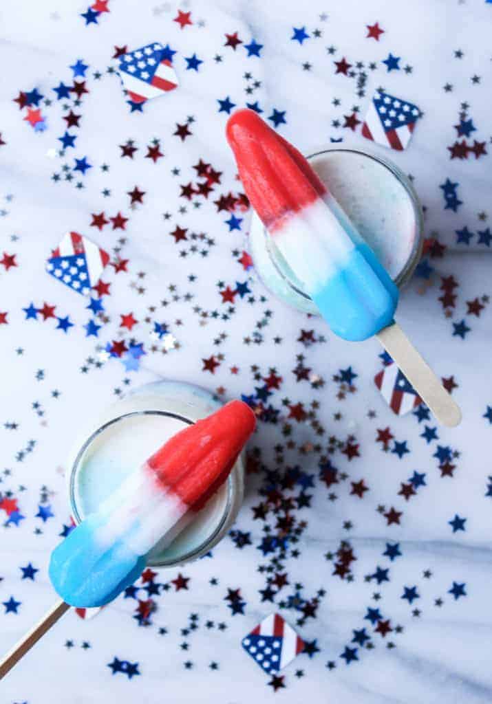 4th of july cocktails surrounded by american flag and star confetti