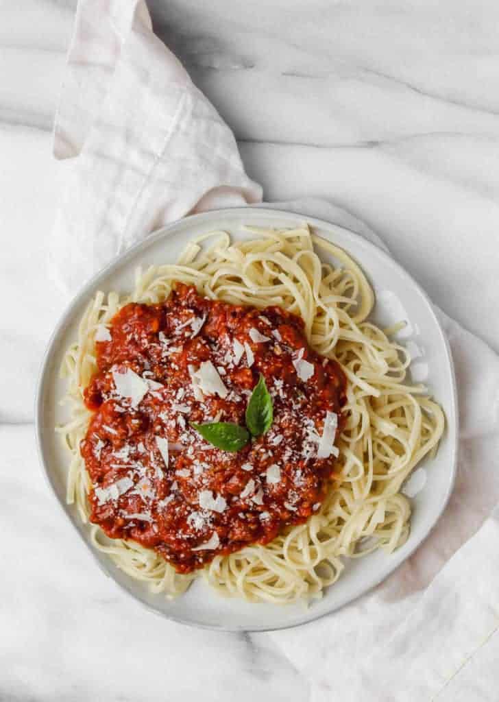 easy homemade spaghetti sauce topped with parmesean and basil
