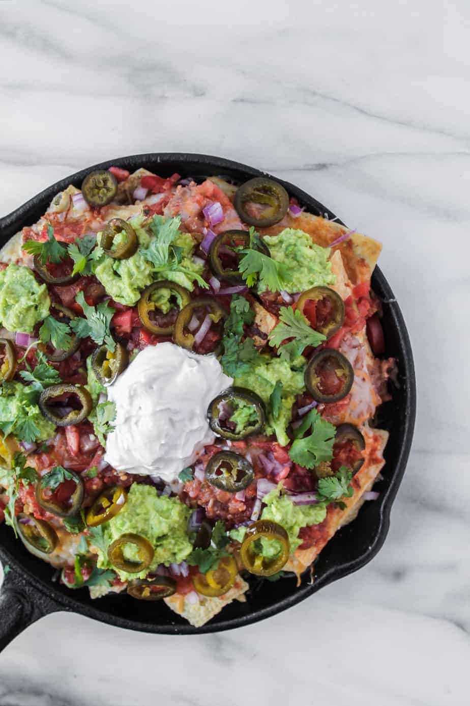 loaded grilled nachos in cast iron skillet