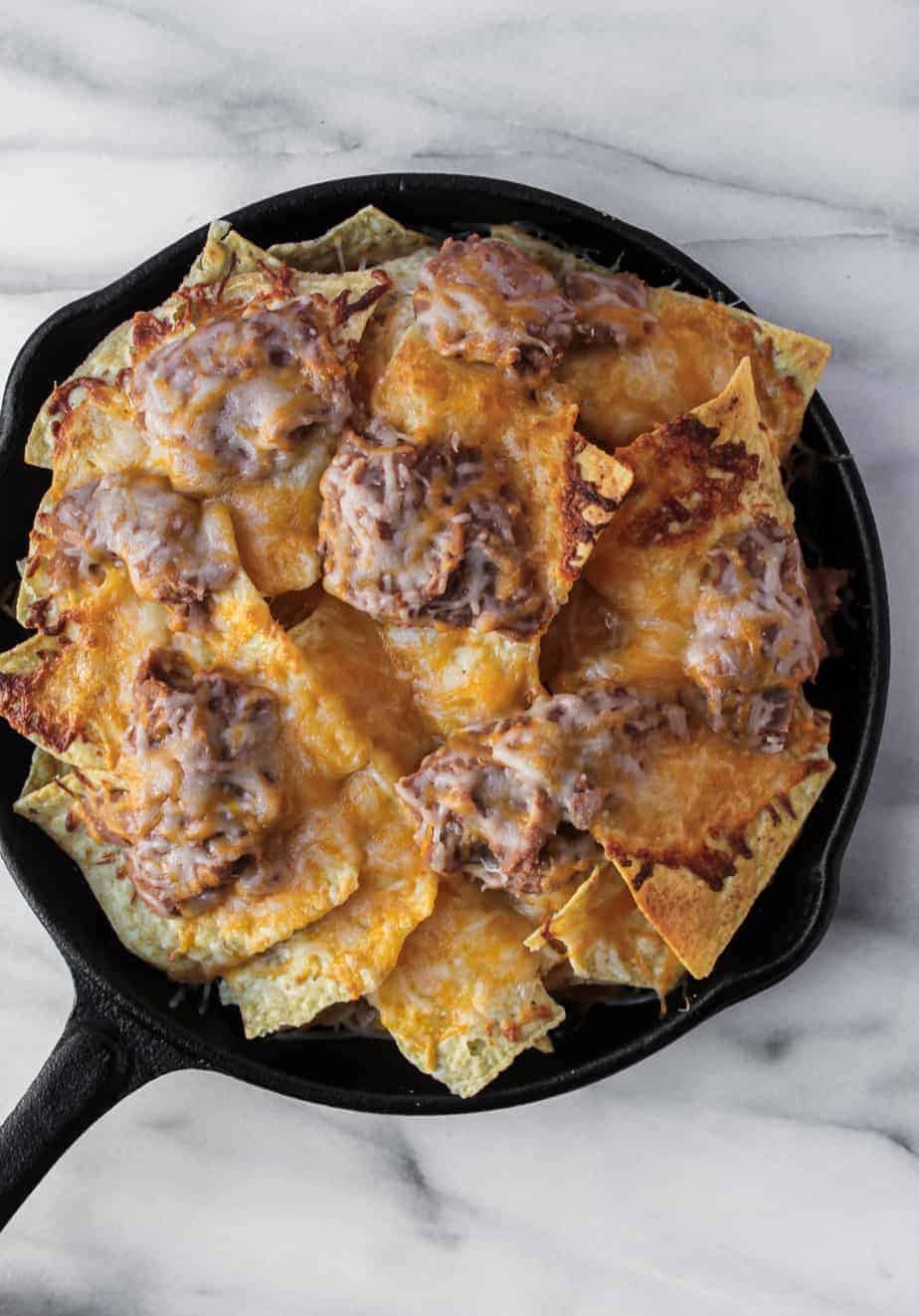 loaded grilled nachos topped with refried beans