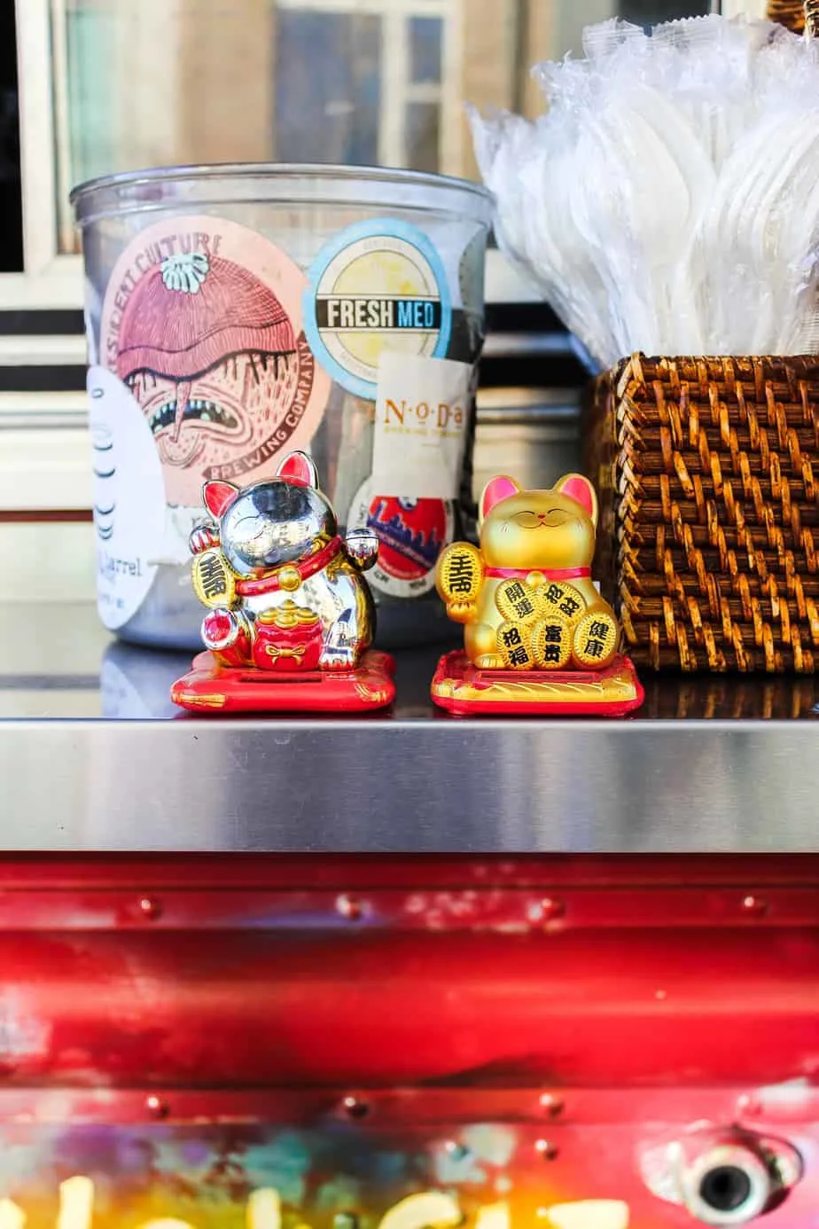 utensils and small cat statutes at the dumpling lady food truck