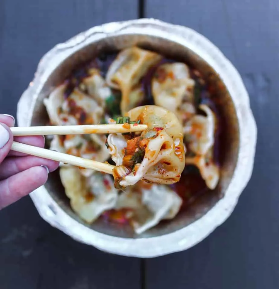the dumpling lady dumplings with chopsticks