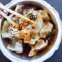 the dumpling lady eating a dumpling