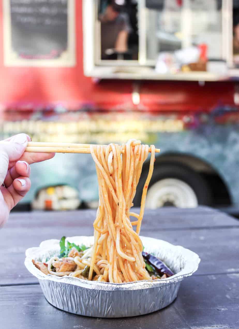 the dumpling lady noodle pull with food truck in the background