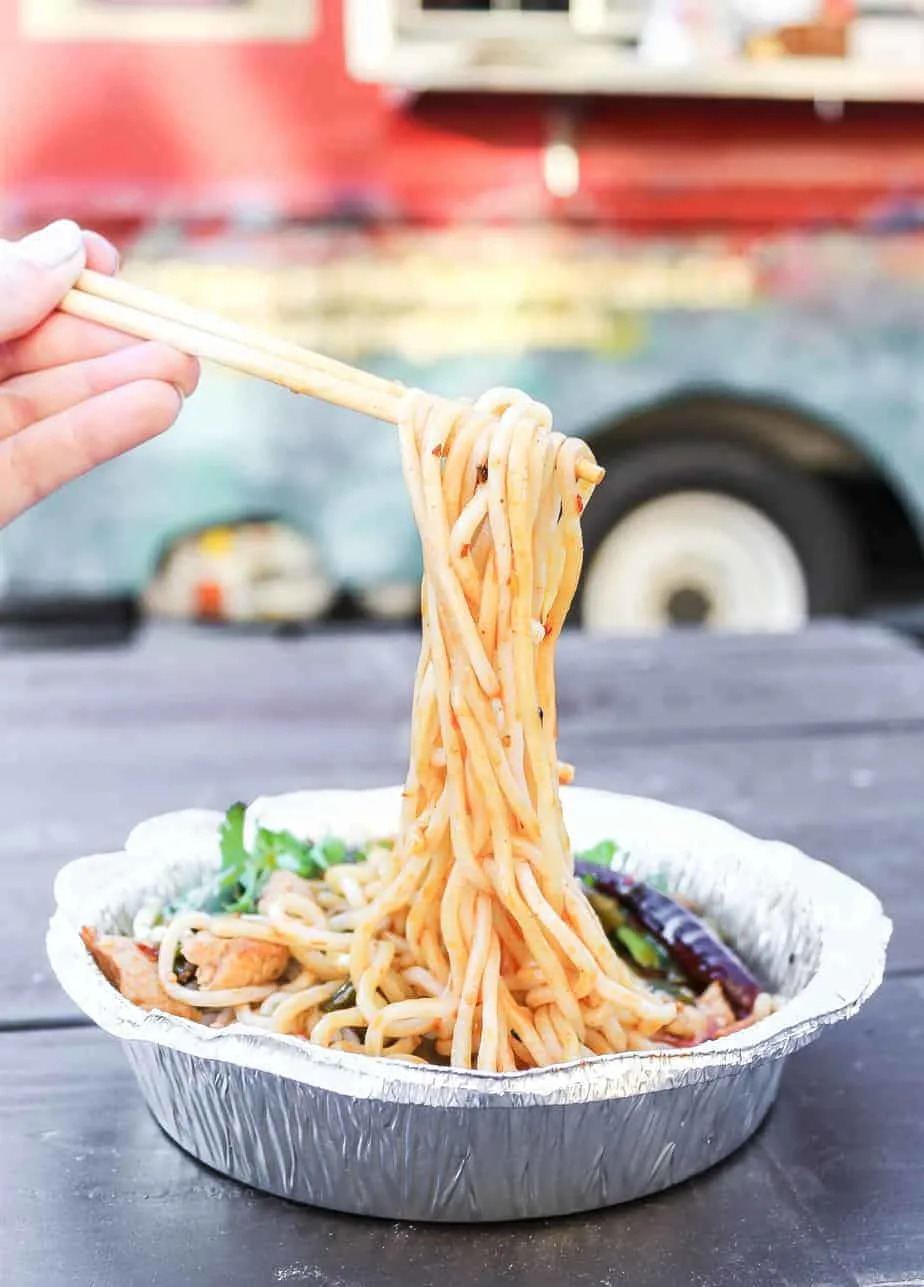 spicy beef noodles pulled out of their container from the dumpling lady food truck