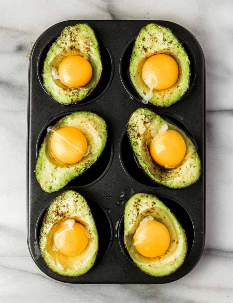 avocado breakfast idea: crack eggs into avocados and while nestled in a muffin tin and bake for a healthy whole30 breakfast 