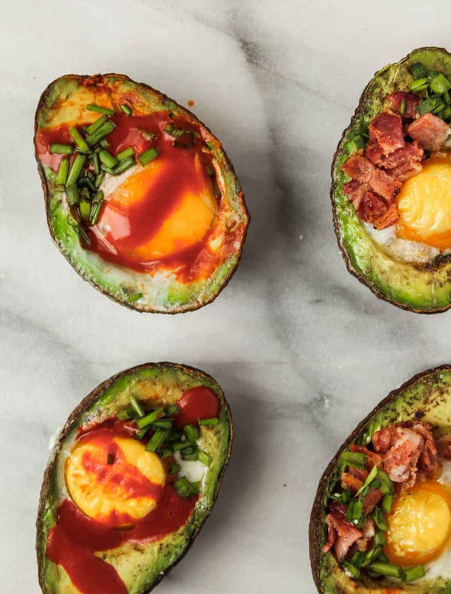 easy whole 30 breakfast recipe idea: baked eggs in avocados with hot sauce