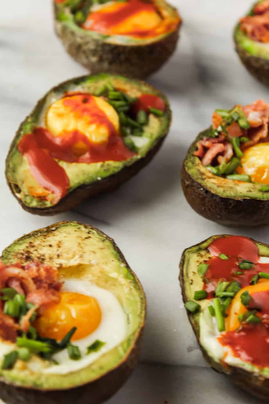 whole30 breakfast ideas: baked eggs in avocado with hot sauce