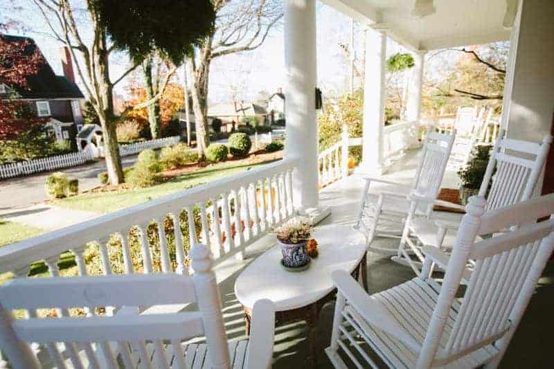 white rocking chairs on the front porch at an asheville bed and breakfast