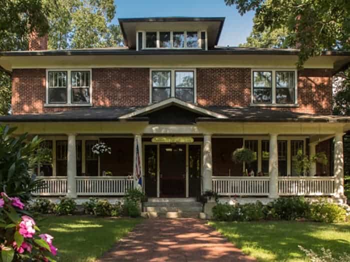 the brick exterior and front porch of the sweet biscuit in an asheville bed and breakfast