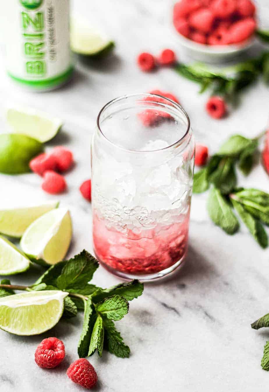 adding gin to raspberry gin rickey cocktail