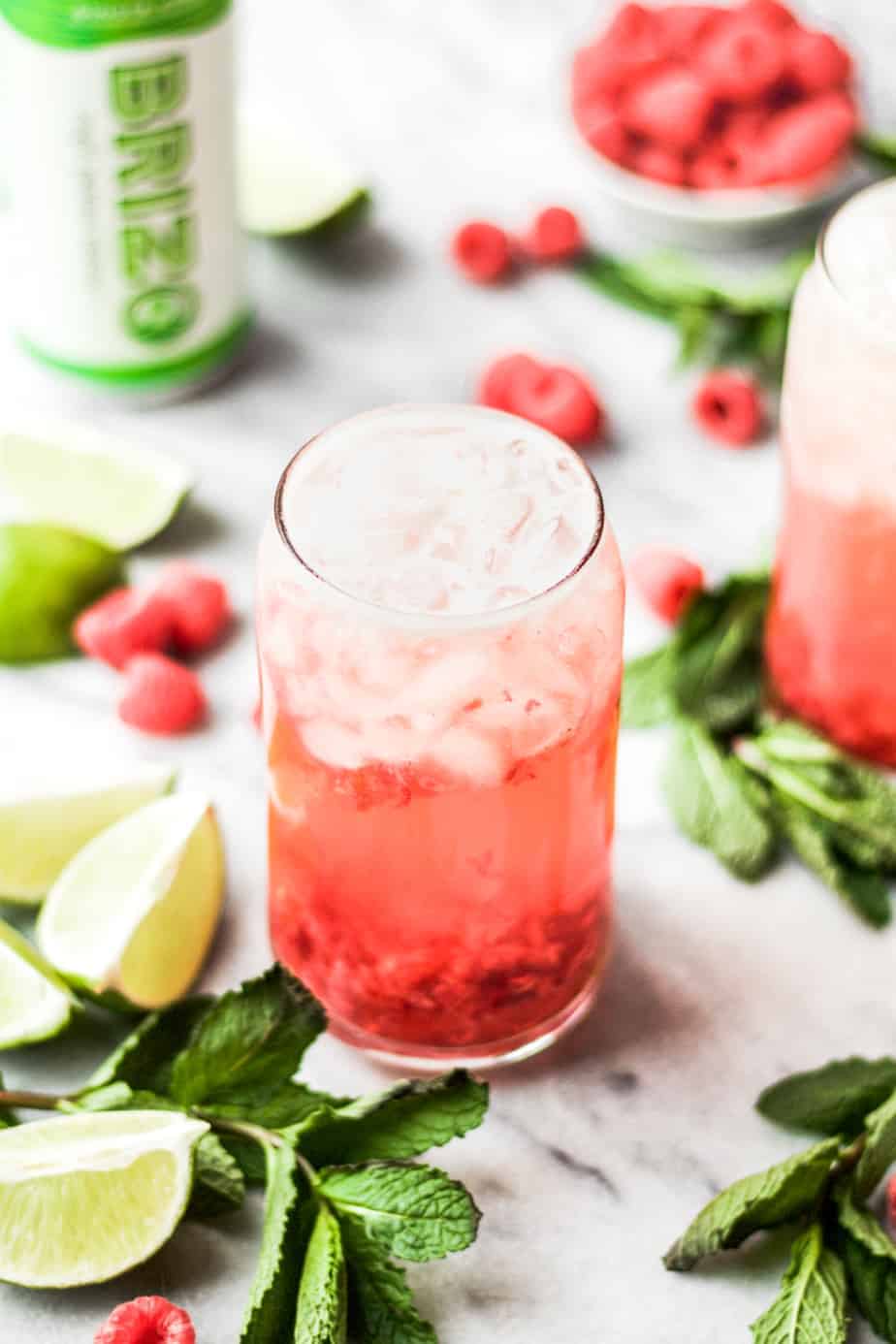 raspberry gin seltzer cocktail with limes raspberries and mint Off
