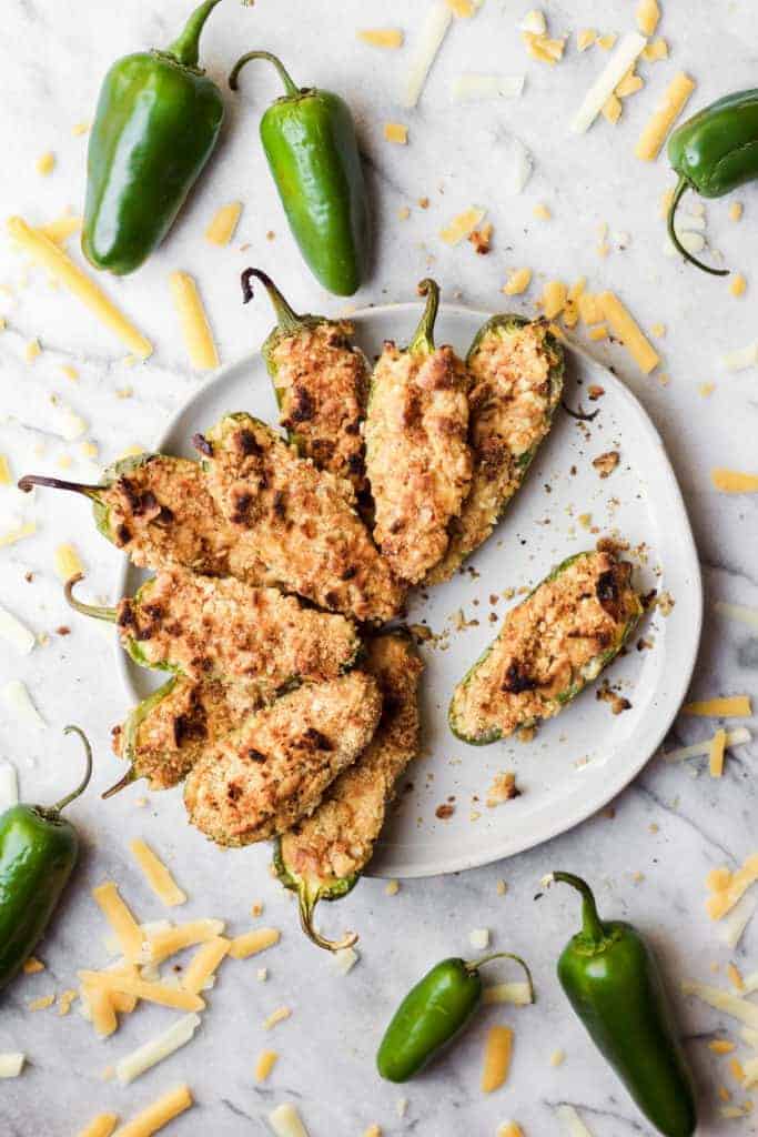 jalpenos cheddar cheese and plate of baked jalapeno poppers