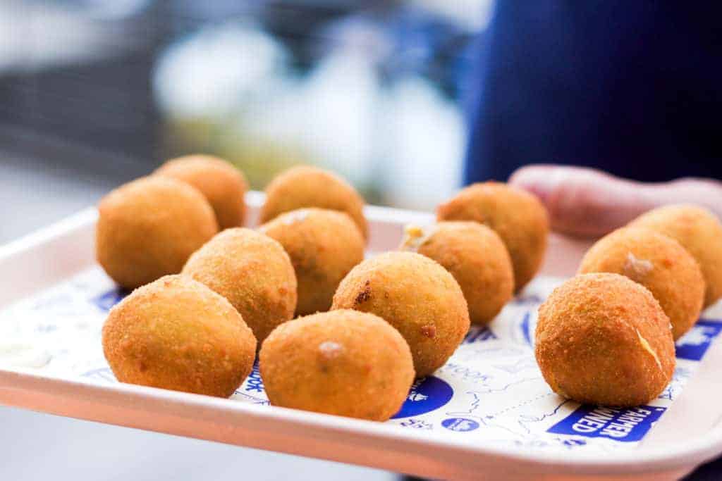padron and cheese stuffed croquetas on a pink serving platter