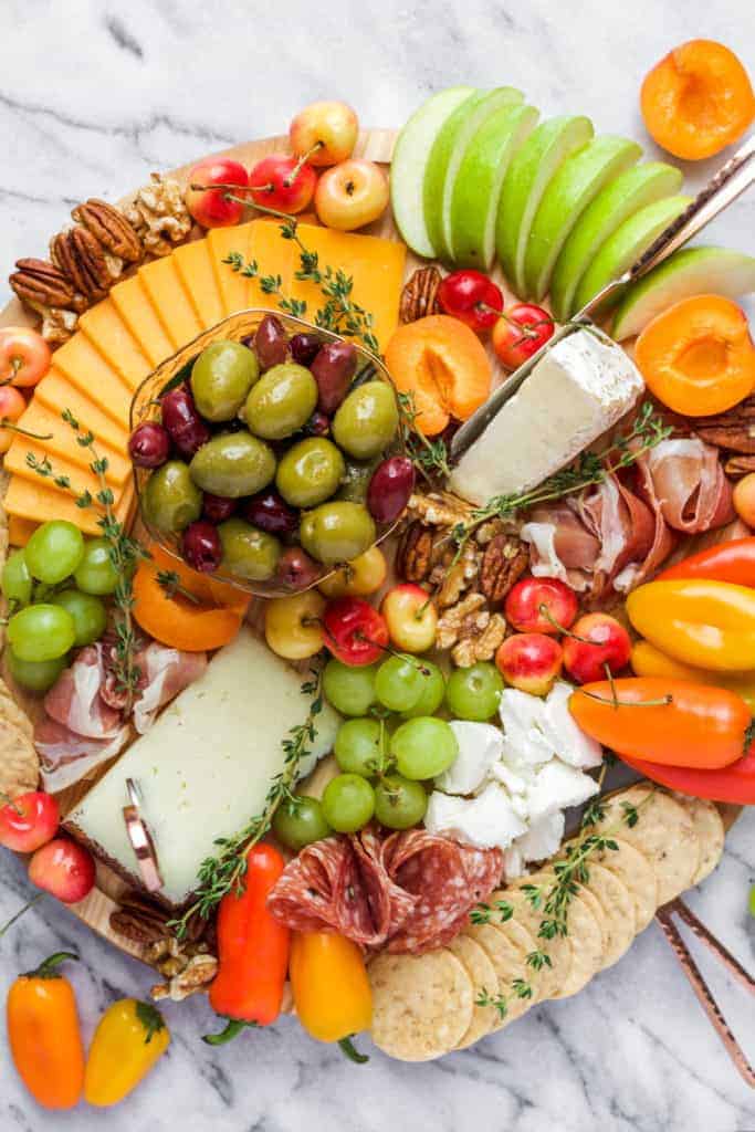 how to make a cheese platter round cheese platter on a marble board with apples and apricots