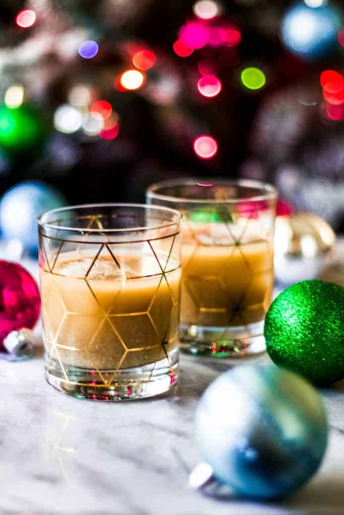 two rocks glasses with christmas white russian cocktails made with eggnog