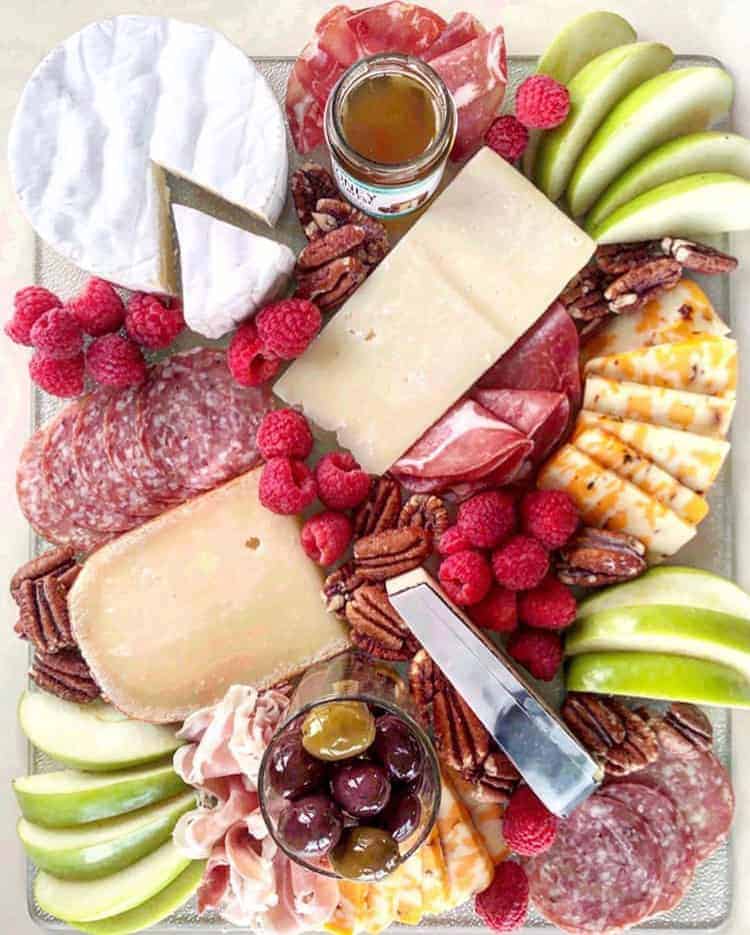 wheel of brie on a cheese platter