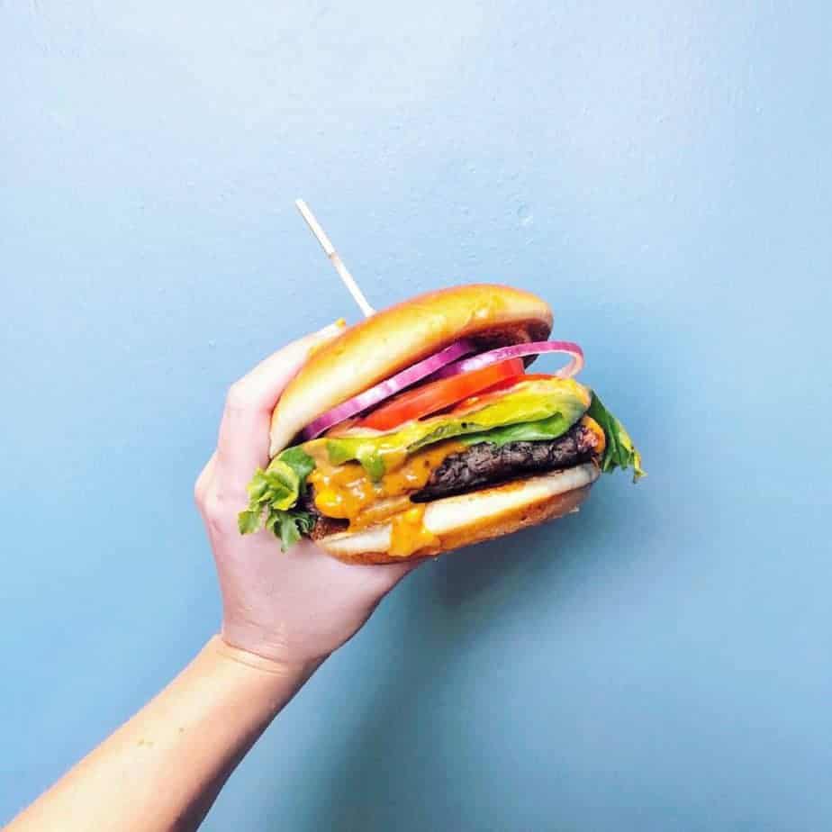 cheeseburger against a blue wall at a charlotte restaurant