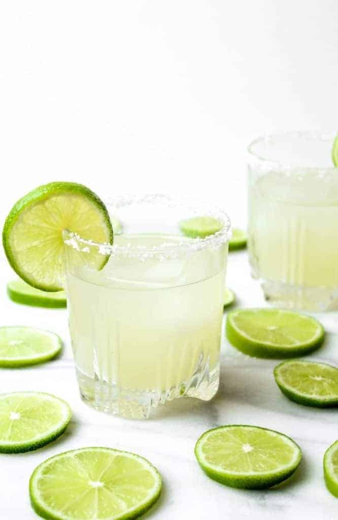 two margaritas and lime slices