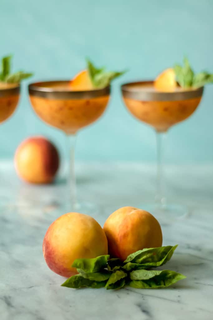 close up picture of two peaches against a blue background