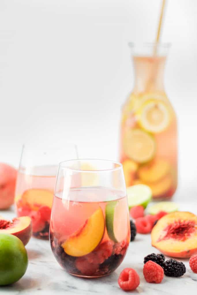 sparkling peach sangria with fresh berries and peaches