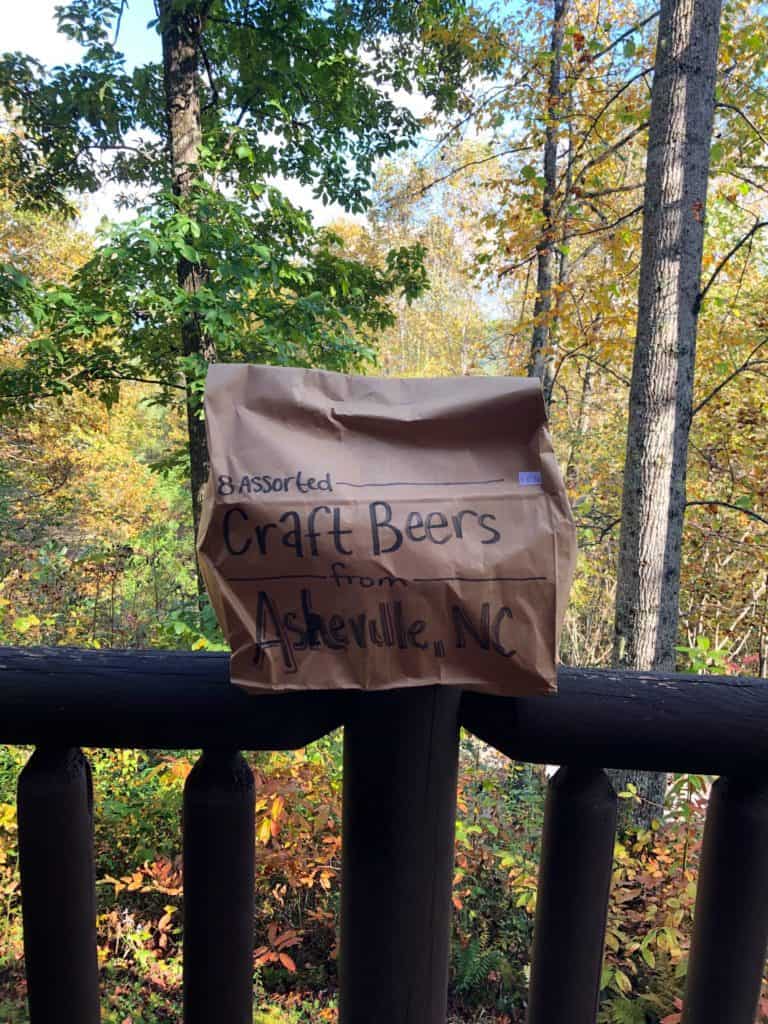 brown bag on top of a railing with trees in the background