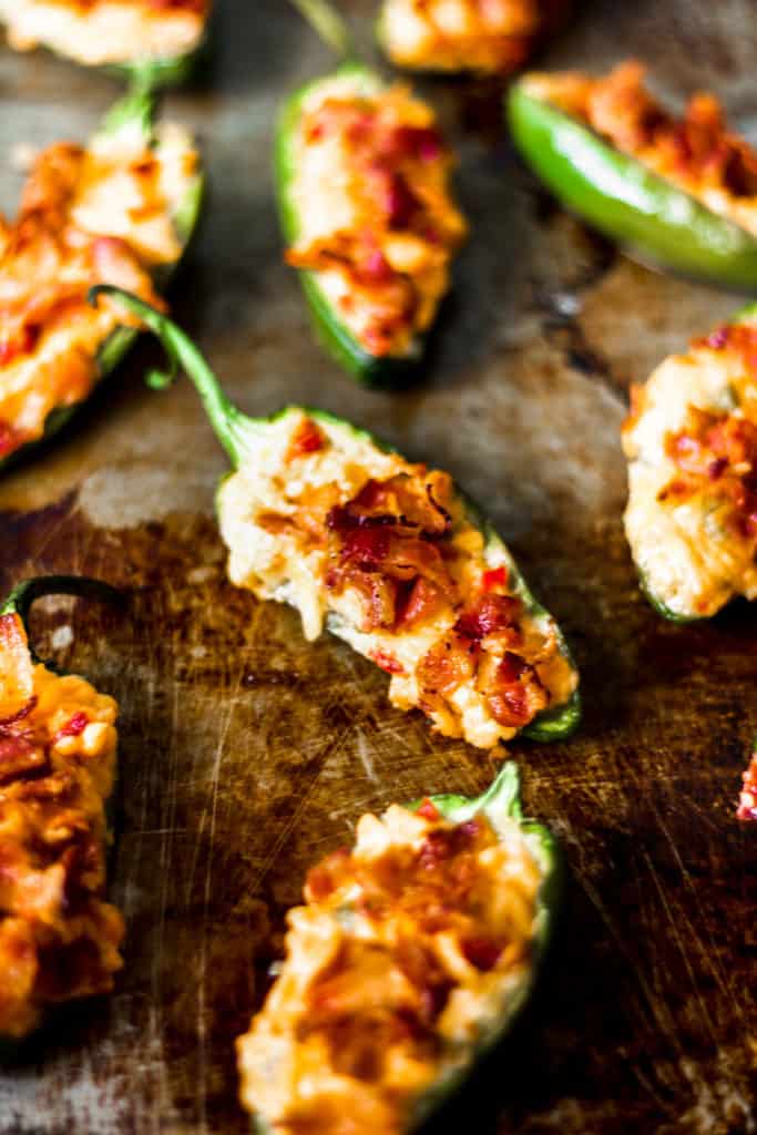 a close up of a half of a jalapeno pepper stuffed with pimento cheese and bacon