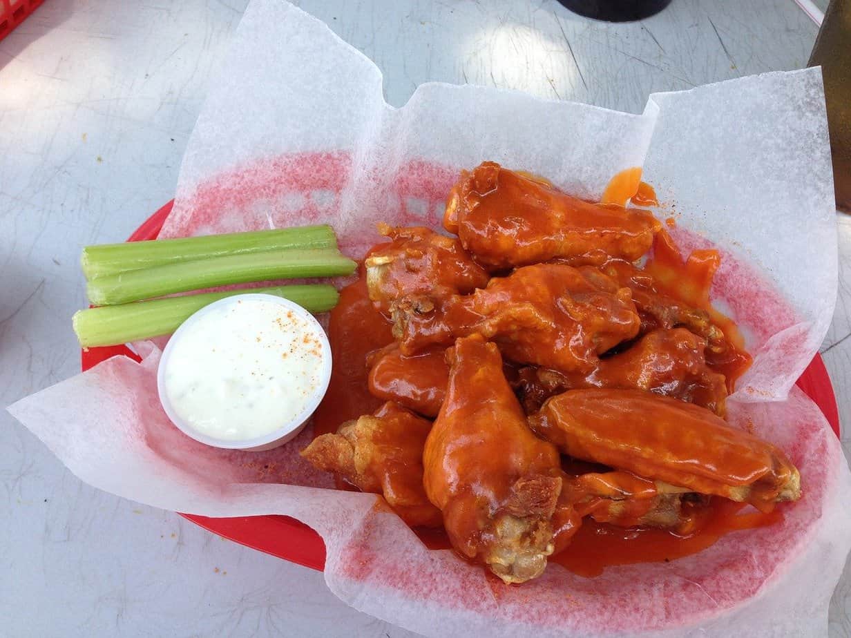 red basket filled with buffalo wings, ranch and celery