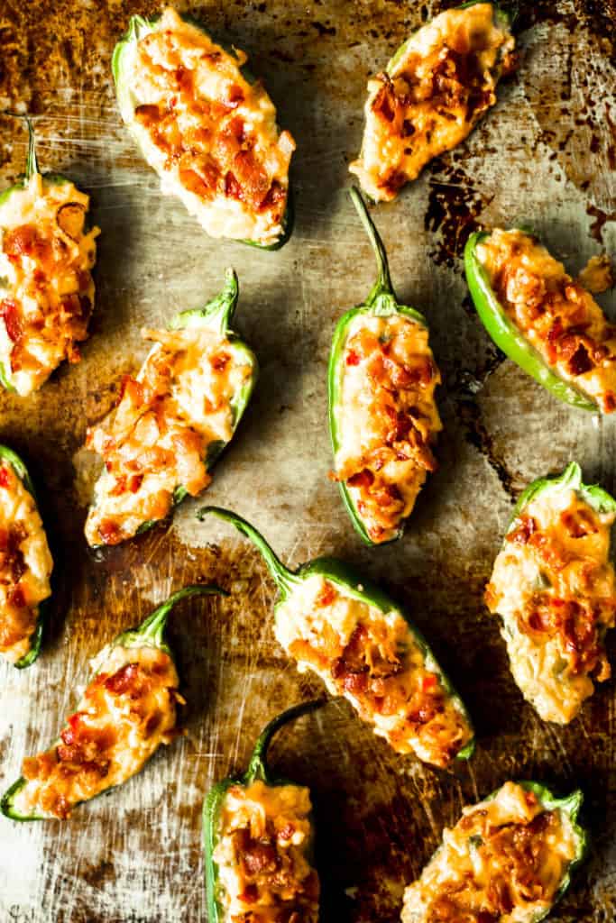 pimento cheese jalapeno poppers on a metal sheet tray