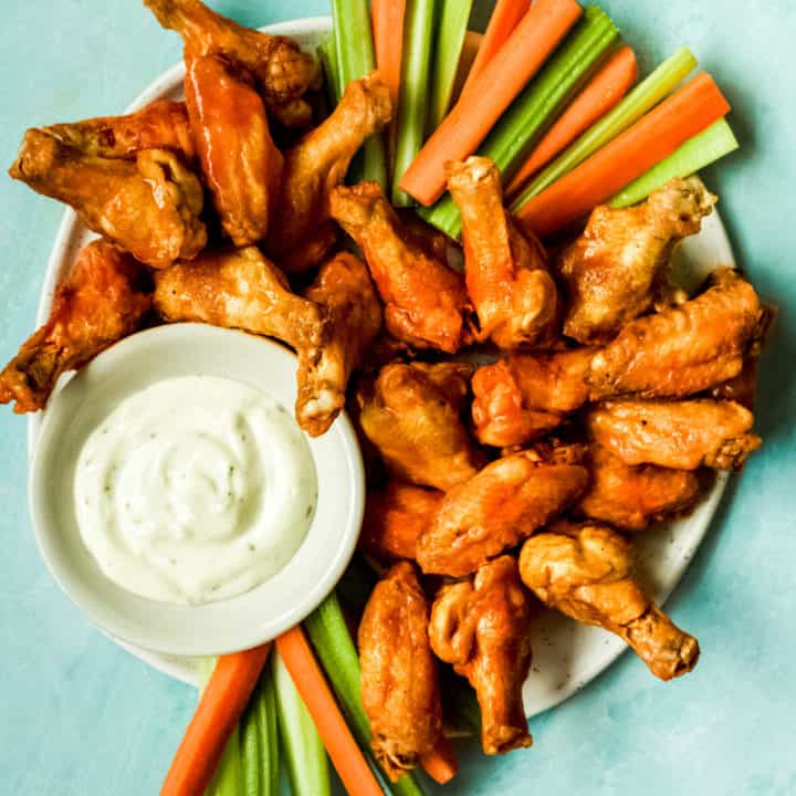 a big plate of buffalo wings, carrots, celery and ranch for dipping