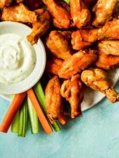 a pile of extra crispy air fryer chicken wings with a side of ranch dressing