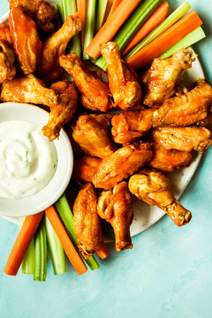 buffalo chicken drumsticks with a bowl of ranch