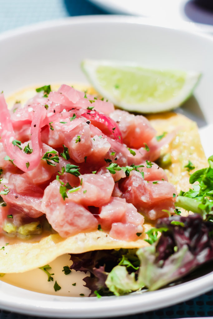 pink tuna ceviche on a crunchy tortilla garnsihed with greens and a lime wedge at bahia beach house in atlantic beach