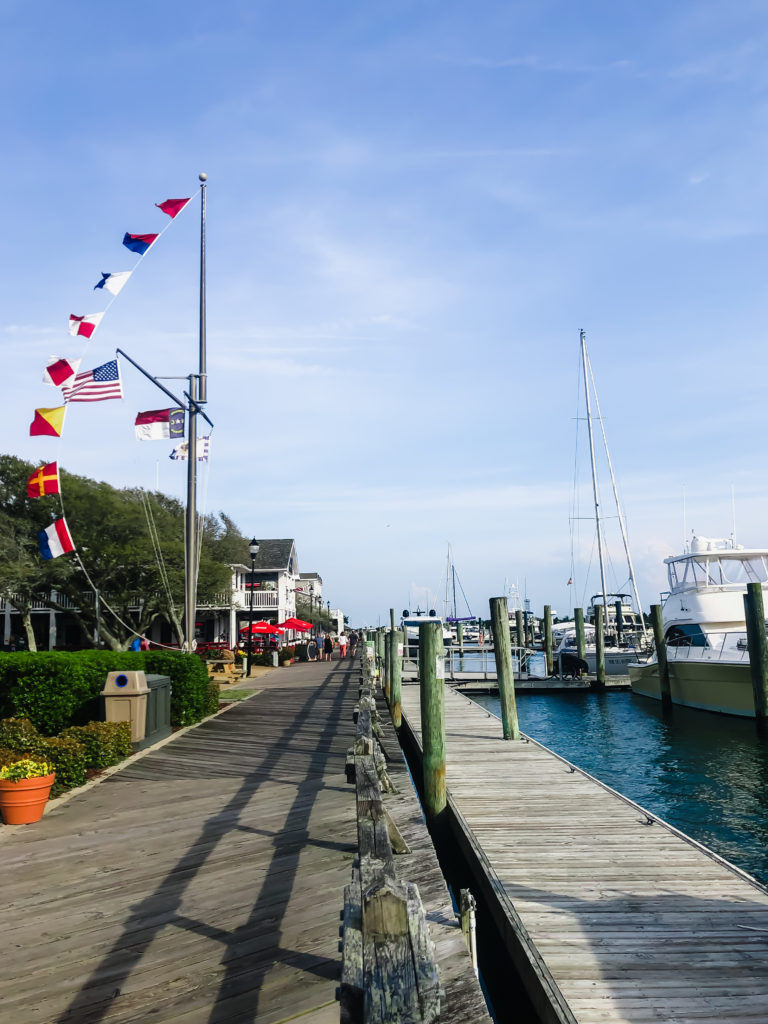 waterfront boardwalk on front street in Beaufort NC with flags waving in the wind