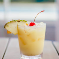 painkiller cocktail in a glass on a wooden table