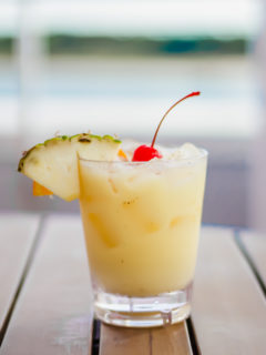 painkiller cocktail in a glass on a wooden table