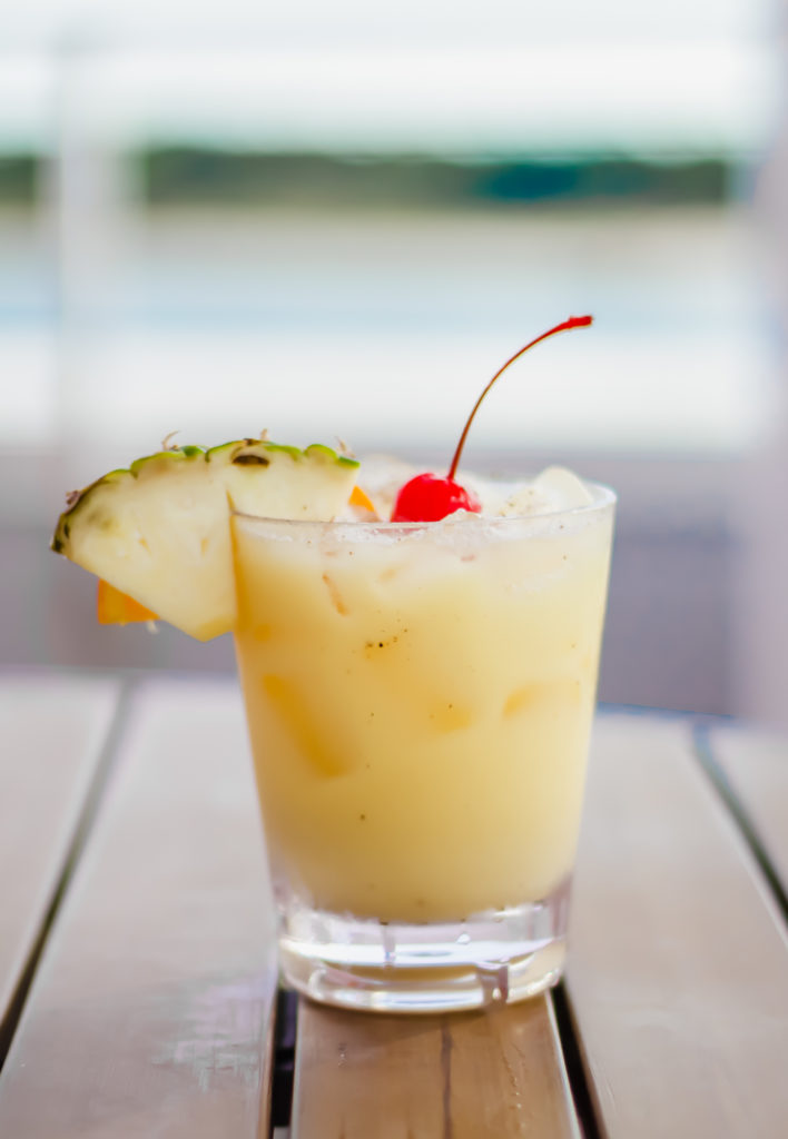 painkiller cocktail in a glass on a wooden table