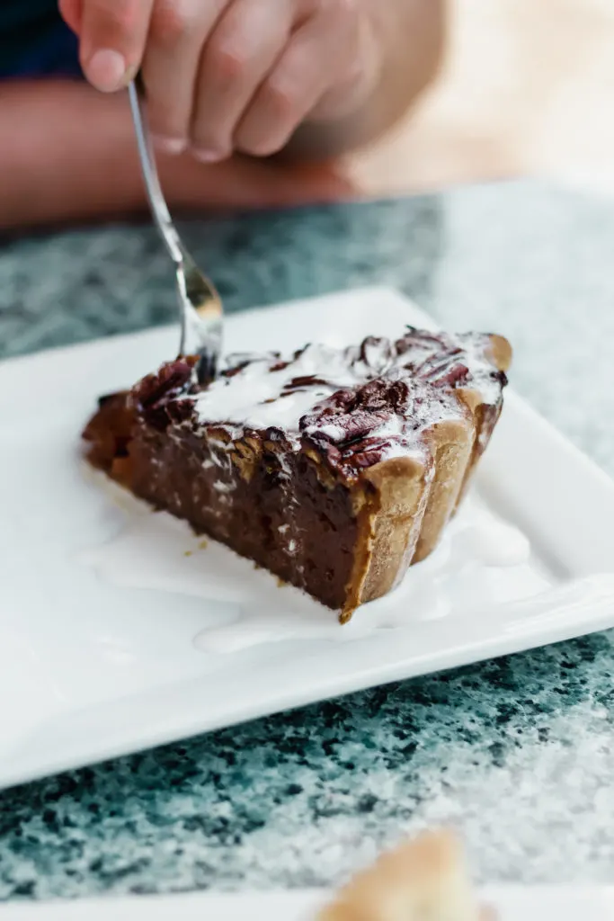 slice of pecan pie on a white plate at beaufort grocery company slice of pecan pie on a white plate at beaufort grocery company