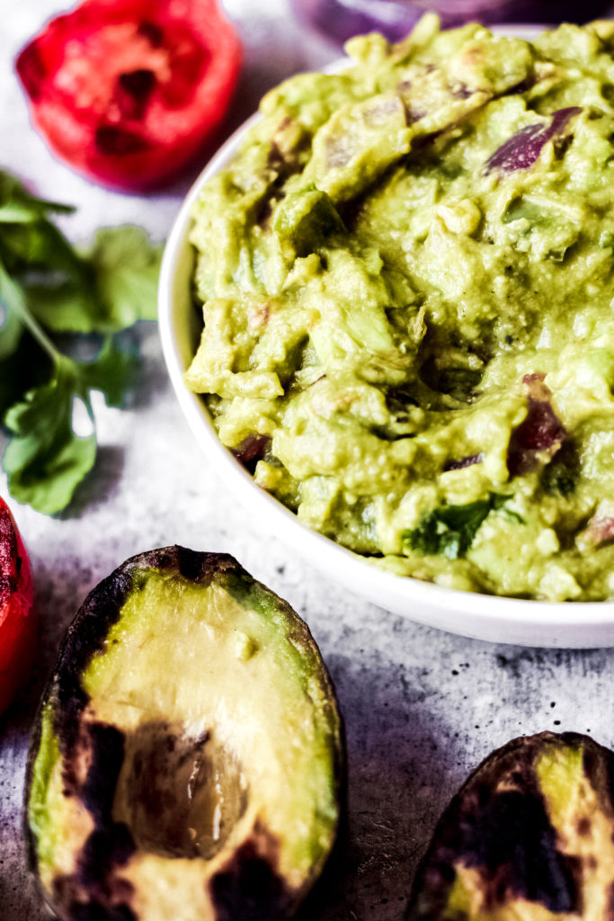 grilled vegan guacamole dip in a white bowl