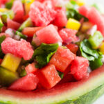 fresh homemade salsa with watermelon in a bowl made out of watermelon rind