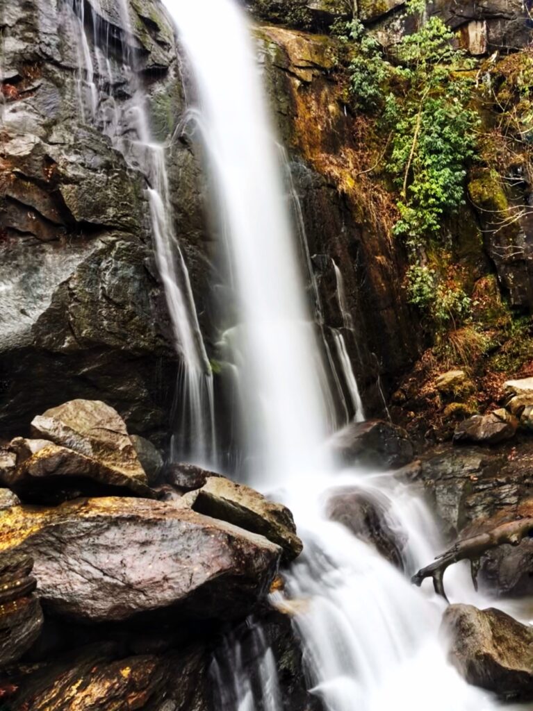 hiking past a waterfall in south mountains state park